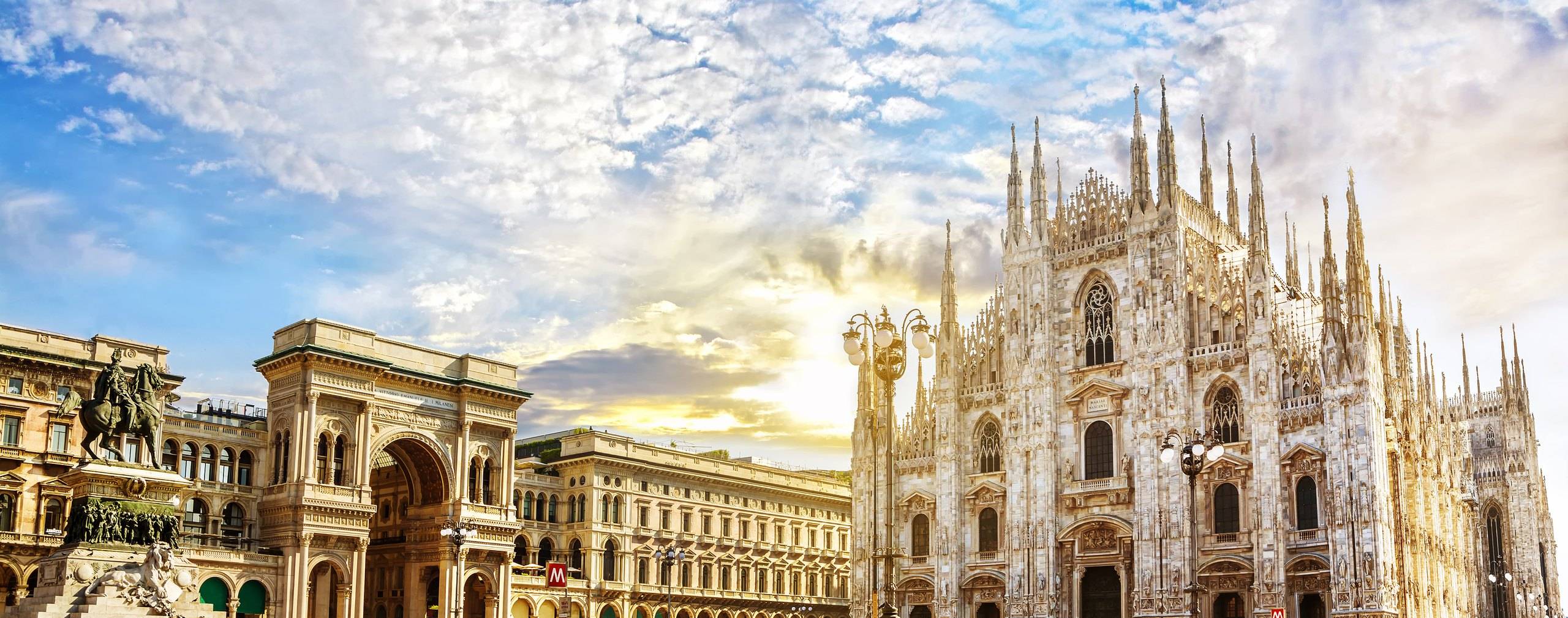 Milan Cathedral and the Galleria Vittorio Emanuele II under a bright sky.